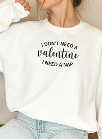 Black sweatshirt shown flat with white 'I Don't Need A Valentine' text across chest.