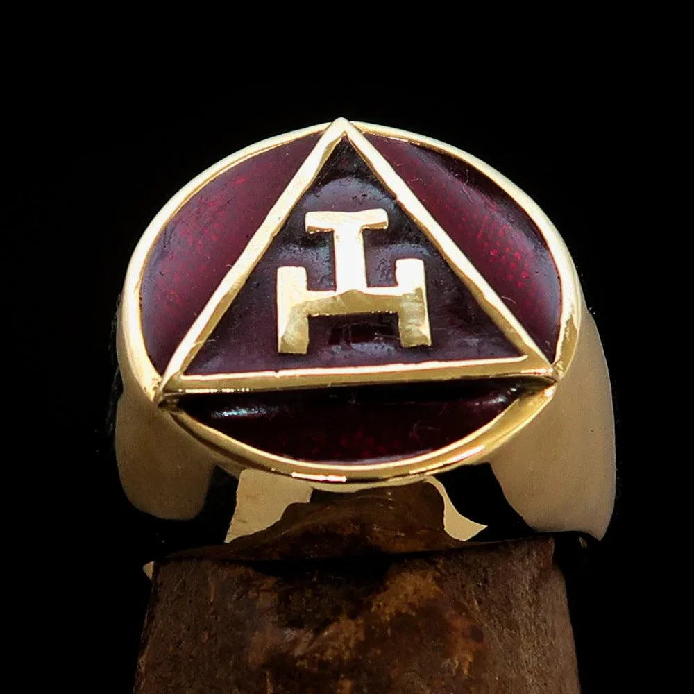 Side view of a polished solid brass Masonic pinky ring showcasing red enamel detail.