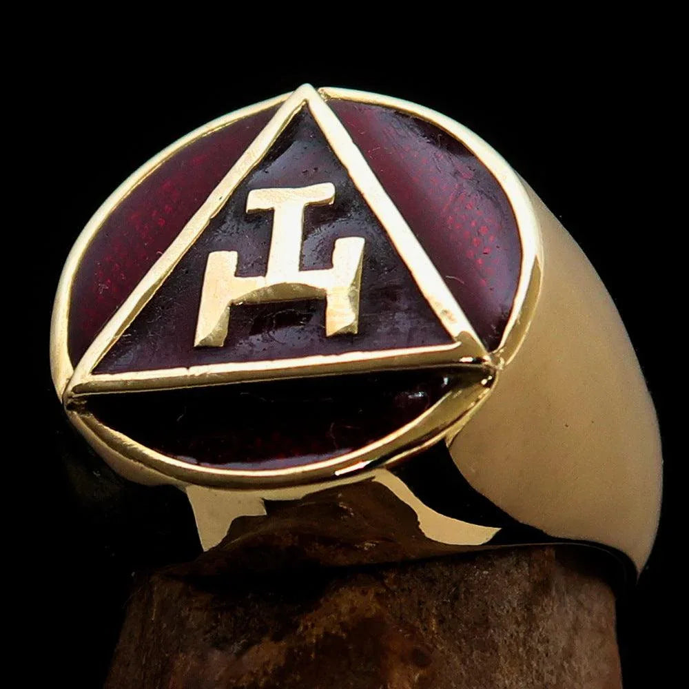 Red enamel Masonic ring displayed beside its black cushioned jewelry box.