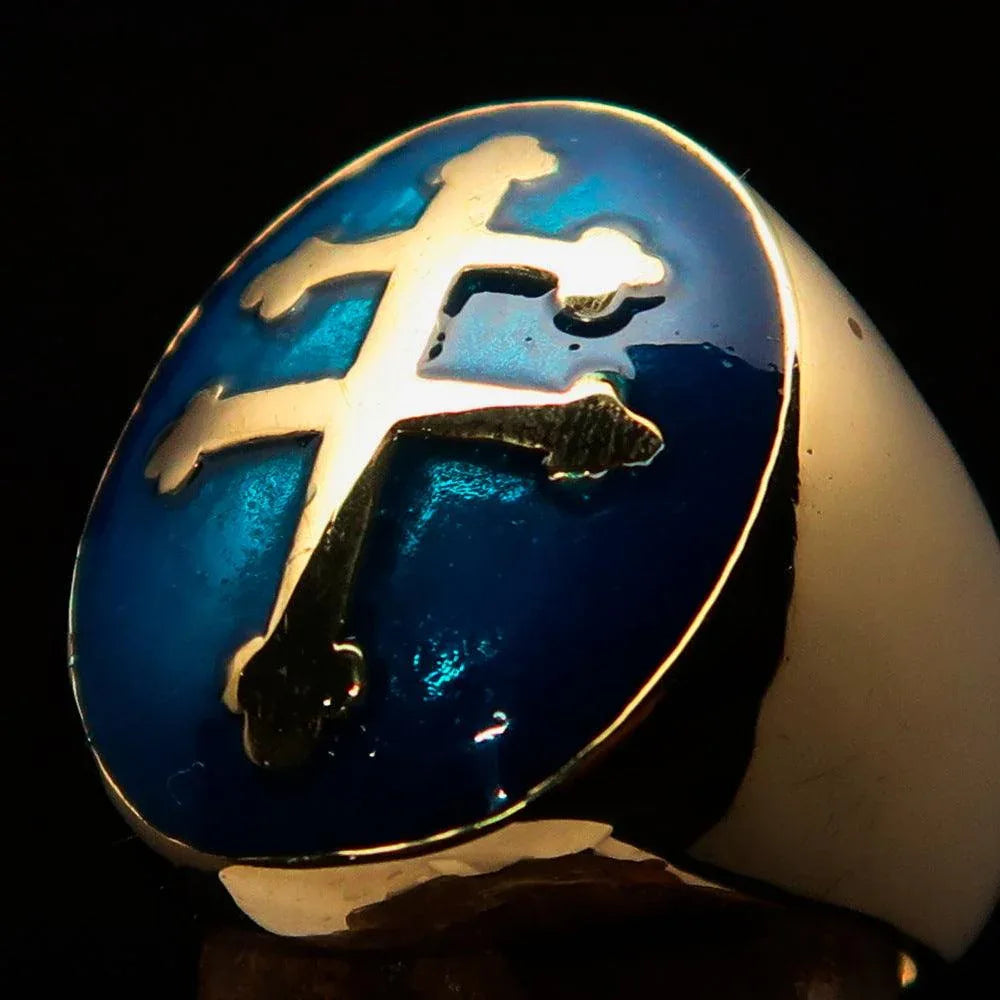 Men's oval domed ring with blue Cross Lorraine design angled view on dark background.