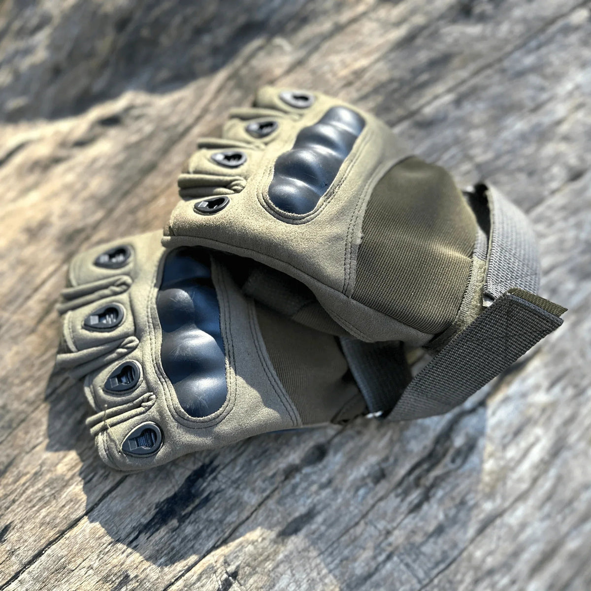 Back of hand view displaying breathable mesh fabric and fingerless design on tactical gloves.