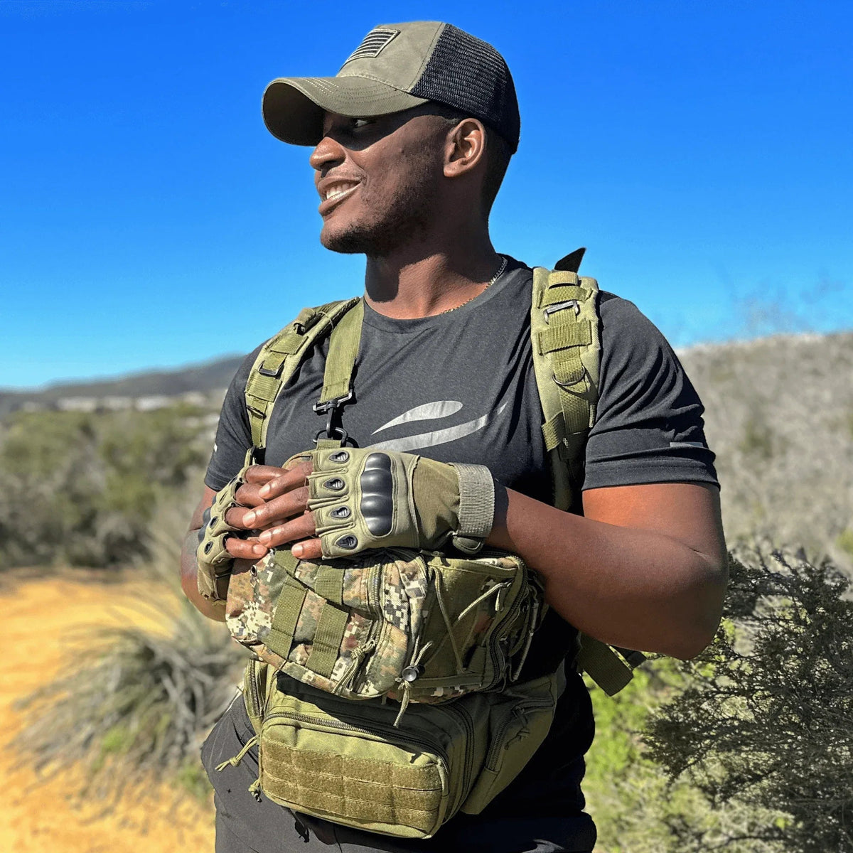 Green tactical gloves worn on hands showing flexibility and secure adjustable wrist closure.