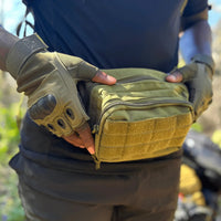 Folded green fingerless gloves emphasizing compact and durable construction for outdoor sports.