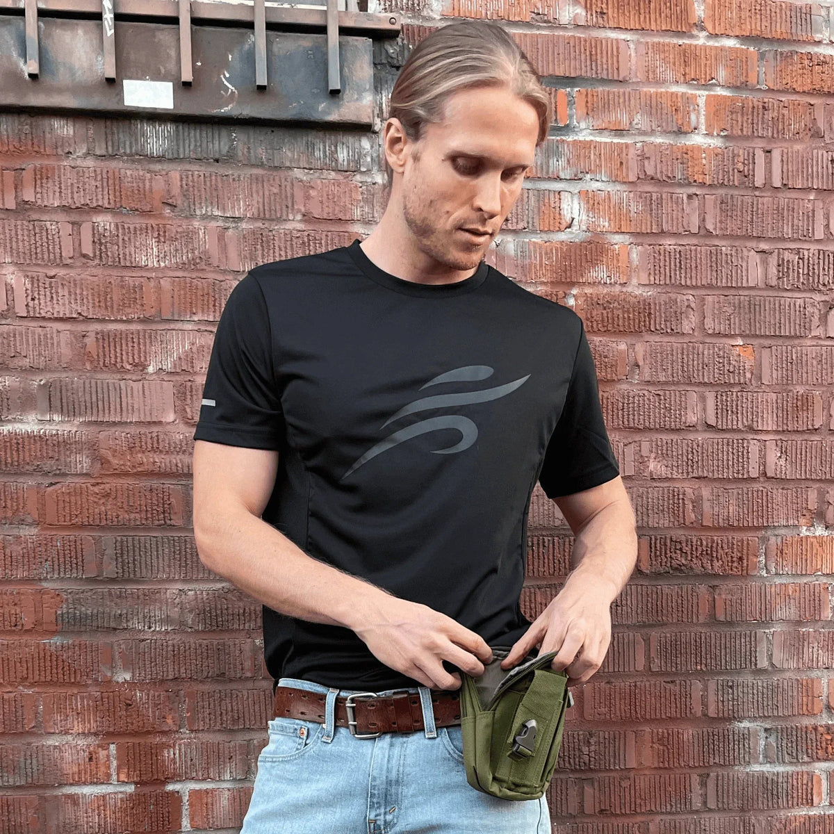 Front view of army green tactical MOLLE pouch displaying its compact size.