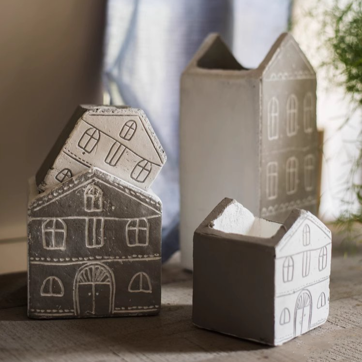 Black TinyHome Clay Planter on wooden surface with soft lighting emphasizing matte texture.