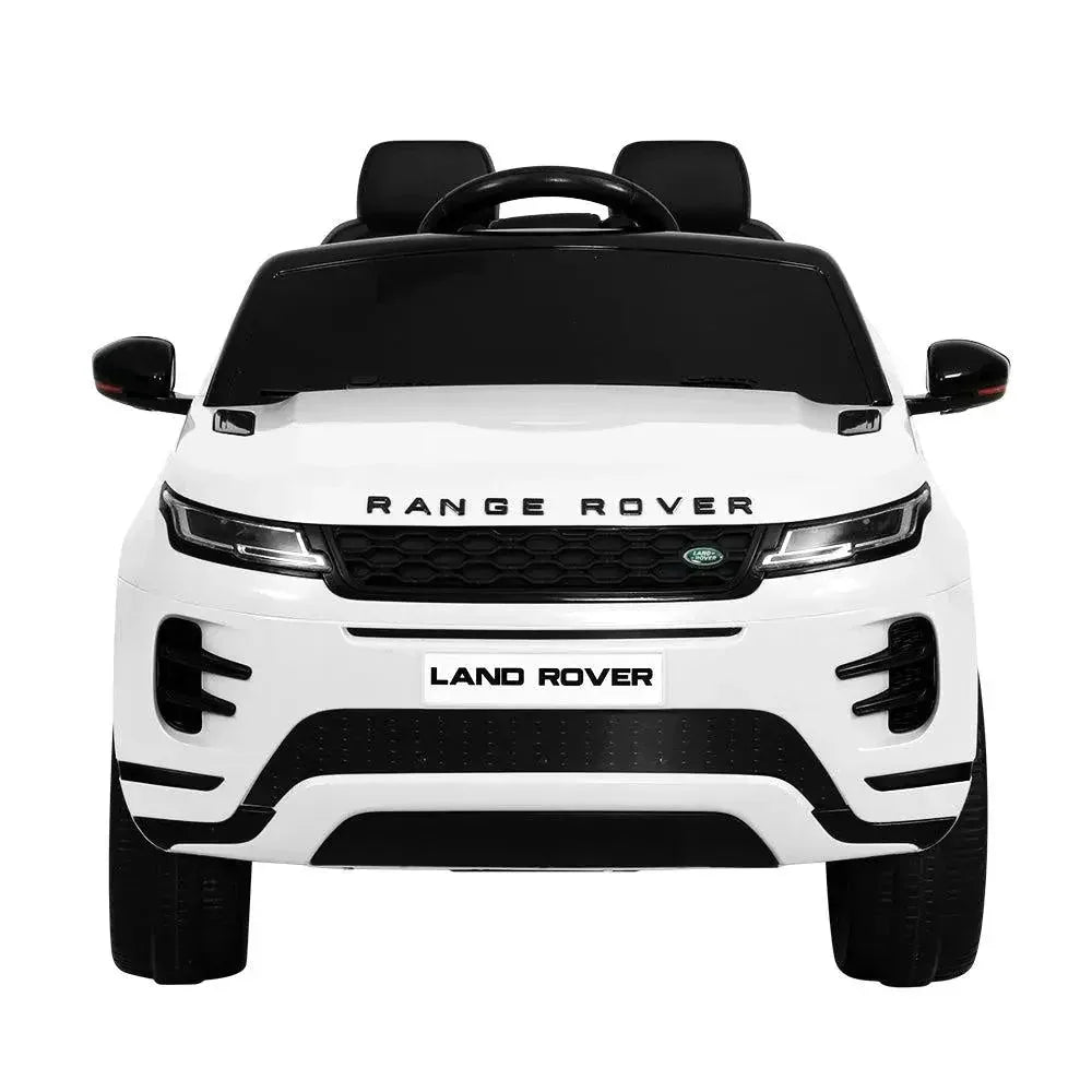 Front angle of white kids 12V Land Rover ride on car highlighting headlights and grill.