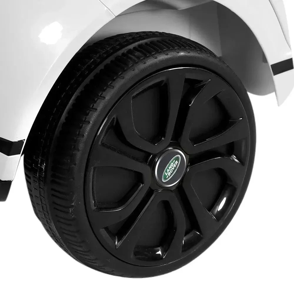 Top view showing white electric Land Rover ride on car's seat and dashboard design.