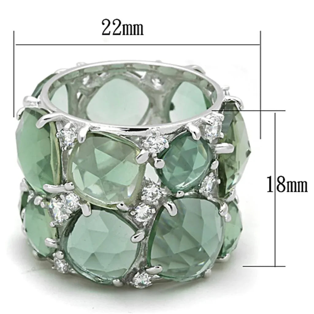 Close-up of silver ring showcasing vibrant emerald synthetic glass center stone with rhodium plating.
