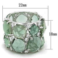 Close-up of silver ring showcasing vibrant emerald synthetic glass center stone with rhodium plating.