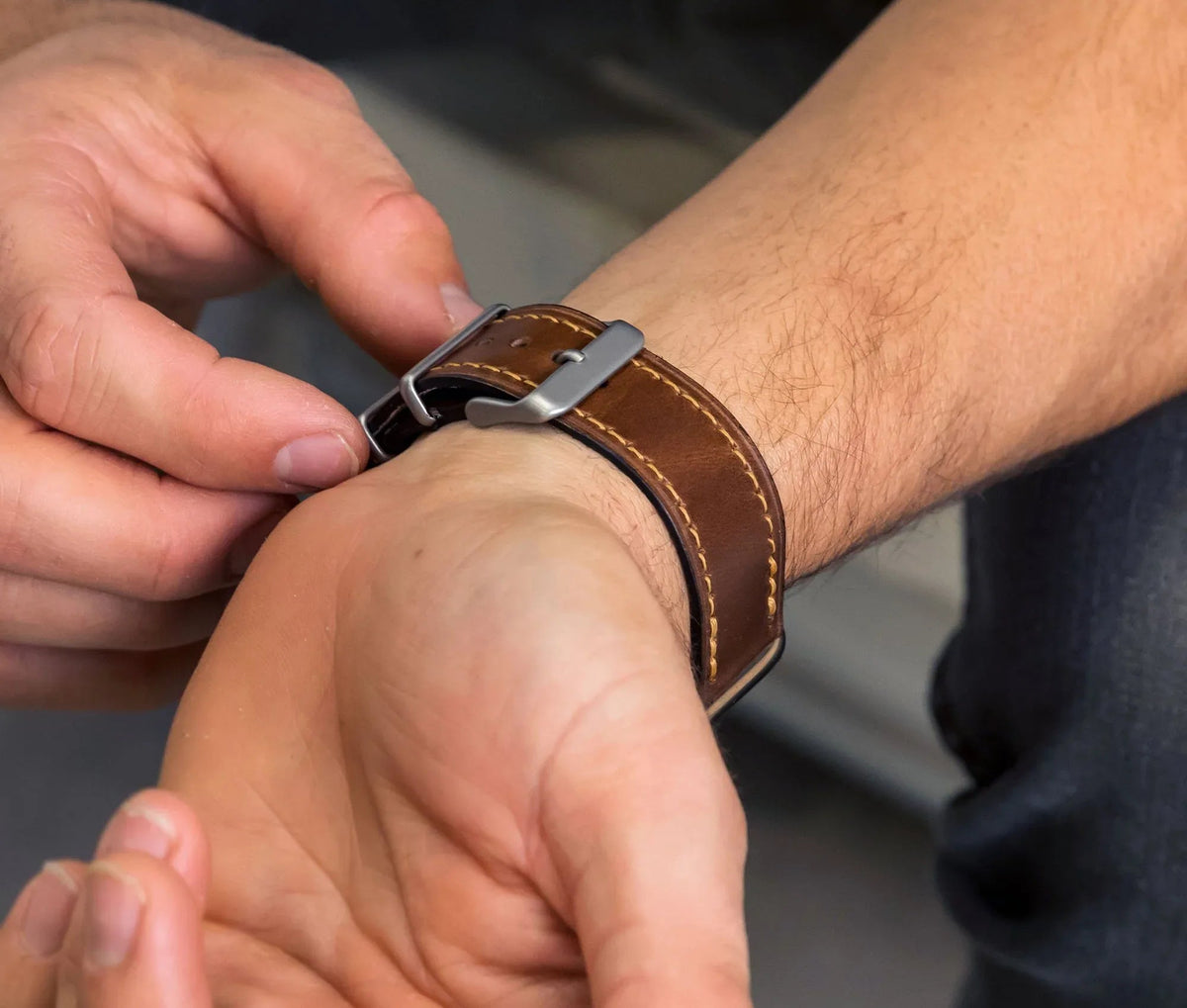 Backside view of brown Apple Band Designer watch band showing smooth leather finish and hardware.