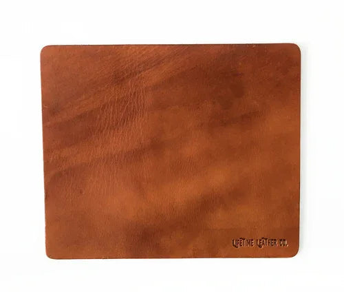 Light brown full grain leather mouse pad shown flat with natural texture visible.