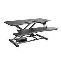 BRATECK Electric sit-stand desk converter with keyboard tray on a modern office desk