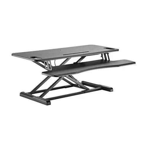 Brateck gas spring sit-stand desk converter with keyboard tray shown on a desk with monitor and office chair