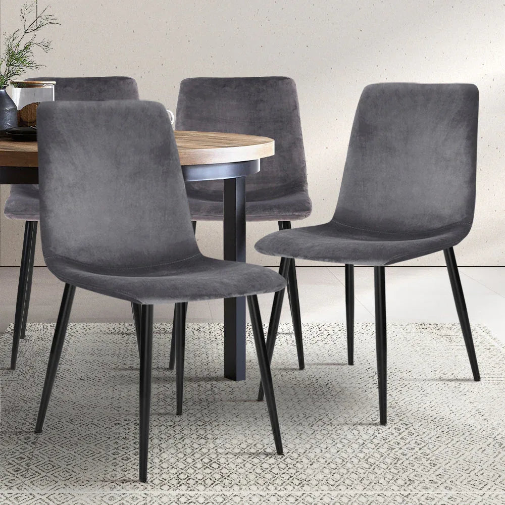 Modern grey velvet dining chair highlighting anti-slip floor protectors on iron legs.
