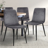 Modern grey velvet dining chair highlighting anti-slip floor protectors on iron legs.