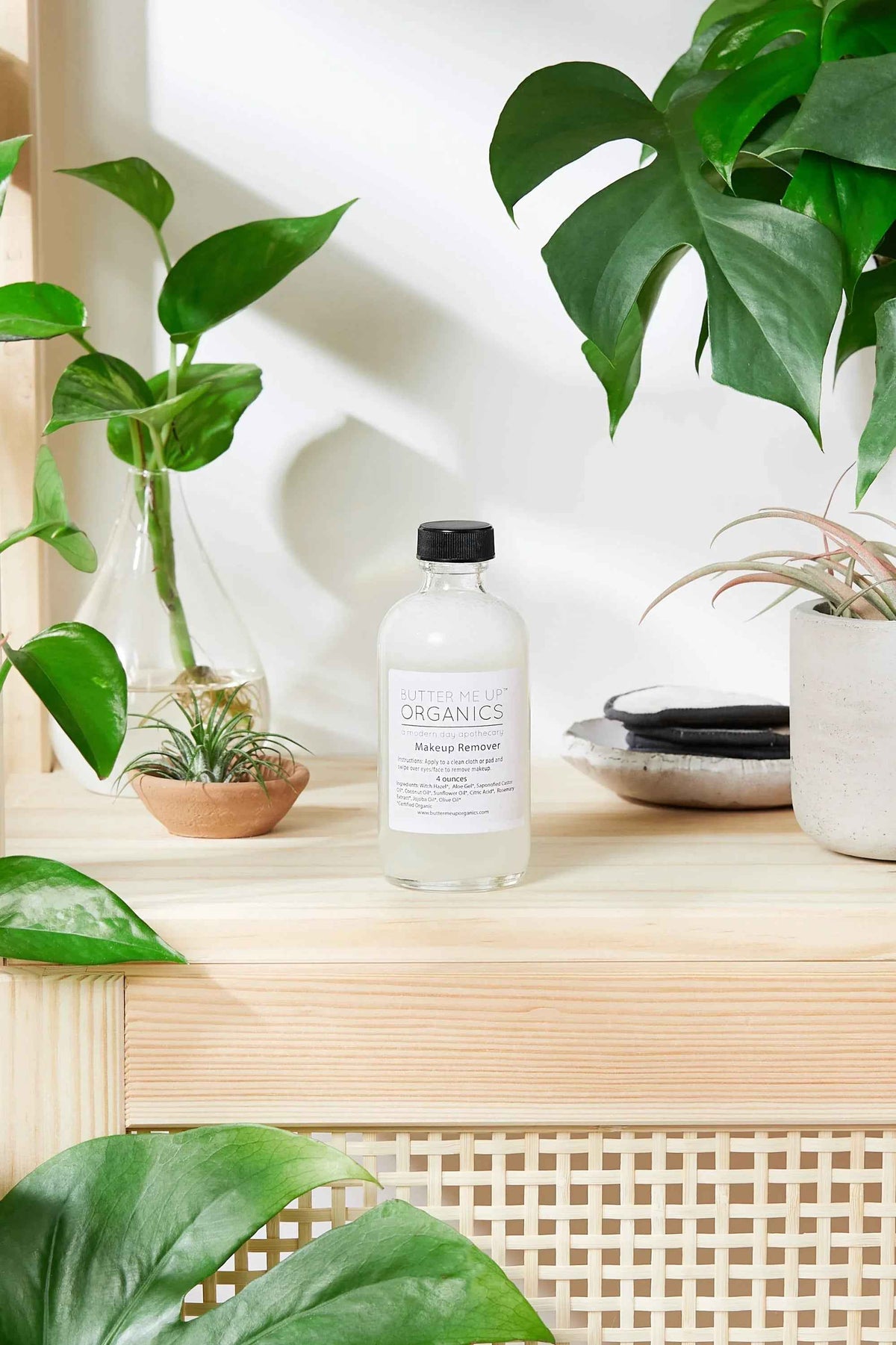 4 oz recycled glass bottle of organic makeup remover from TrustyMall with natural ingredients.