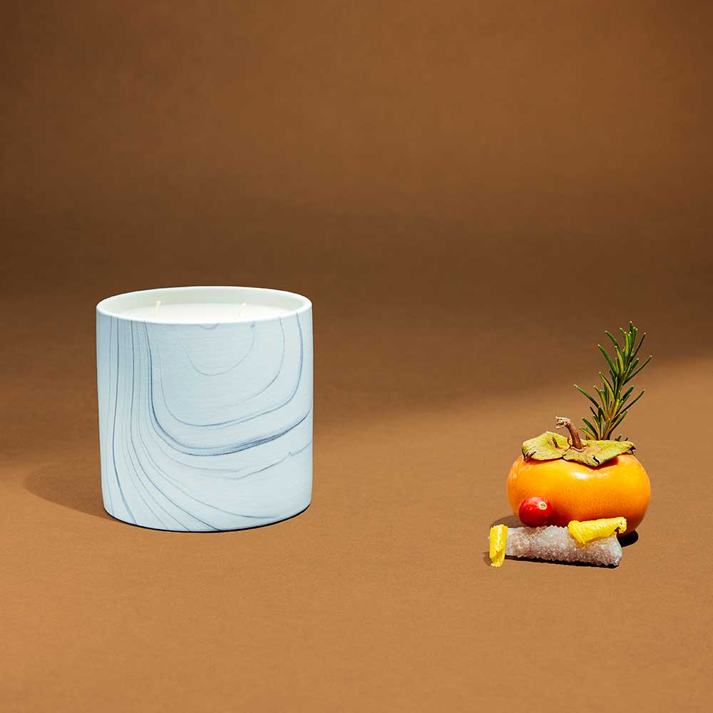 Close-up of hand-painted white marble ceramic candle container with elegant gray and black swirls