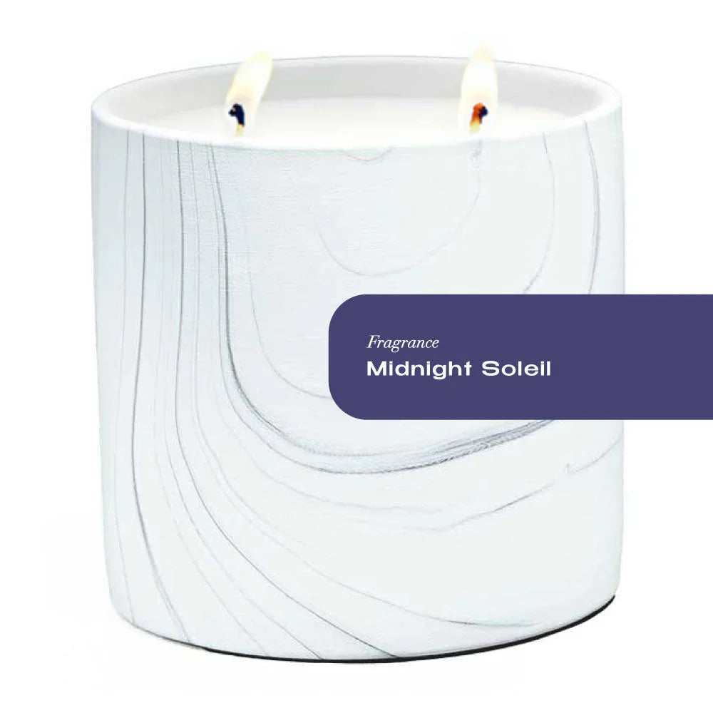 White marble ceramic candle holder with gray and black swirls, filled with a large white candle.