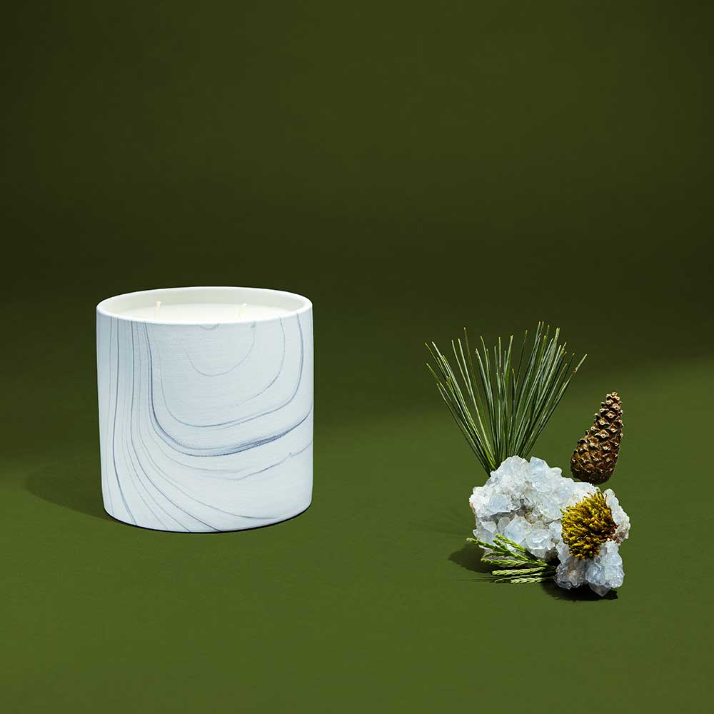 White marble ceramic vessel from Bear Hug candle with soft lighting highlighting its gray and black swirls.
