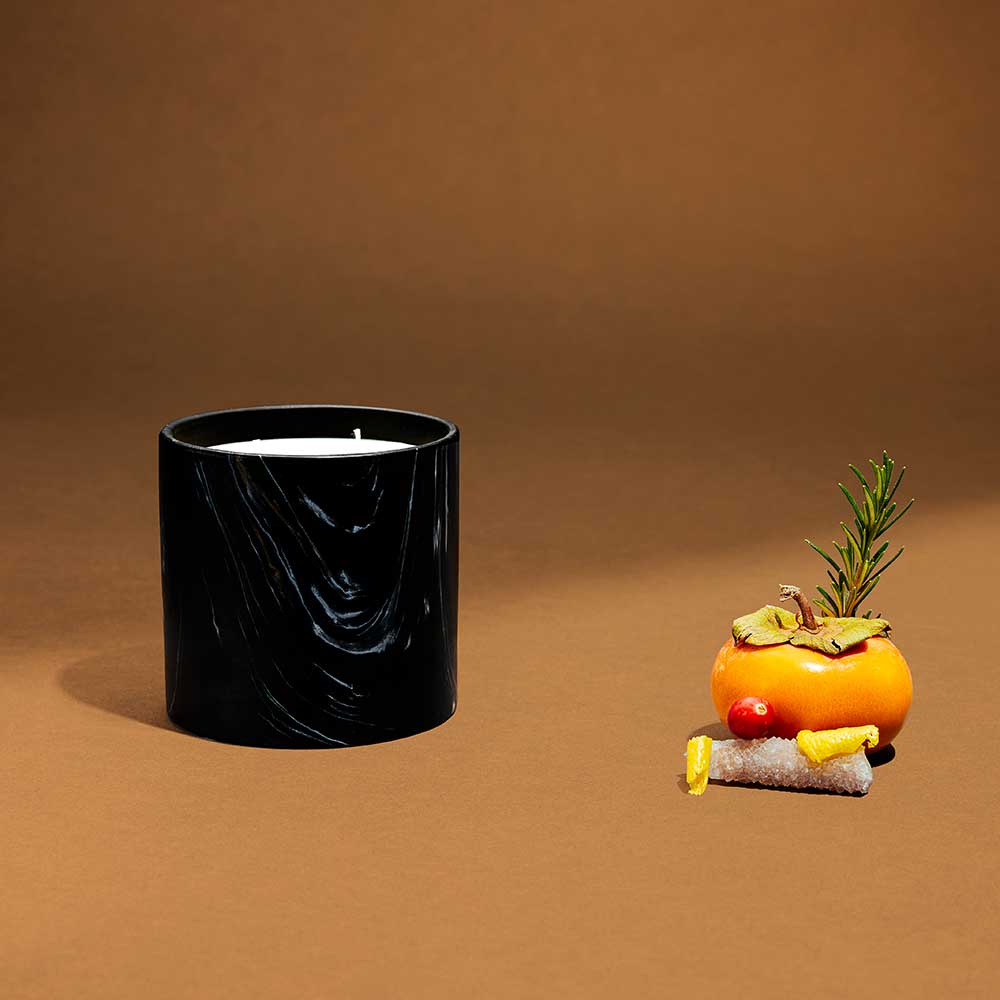 Side view of Dewy Schnozberry 17oz candle in elegant black marquina ceramic container.