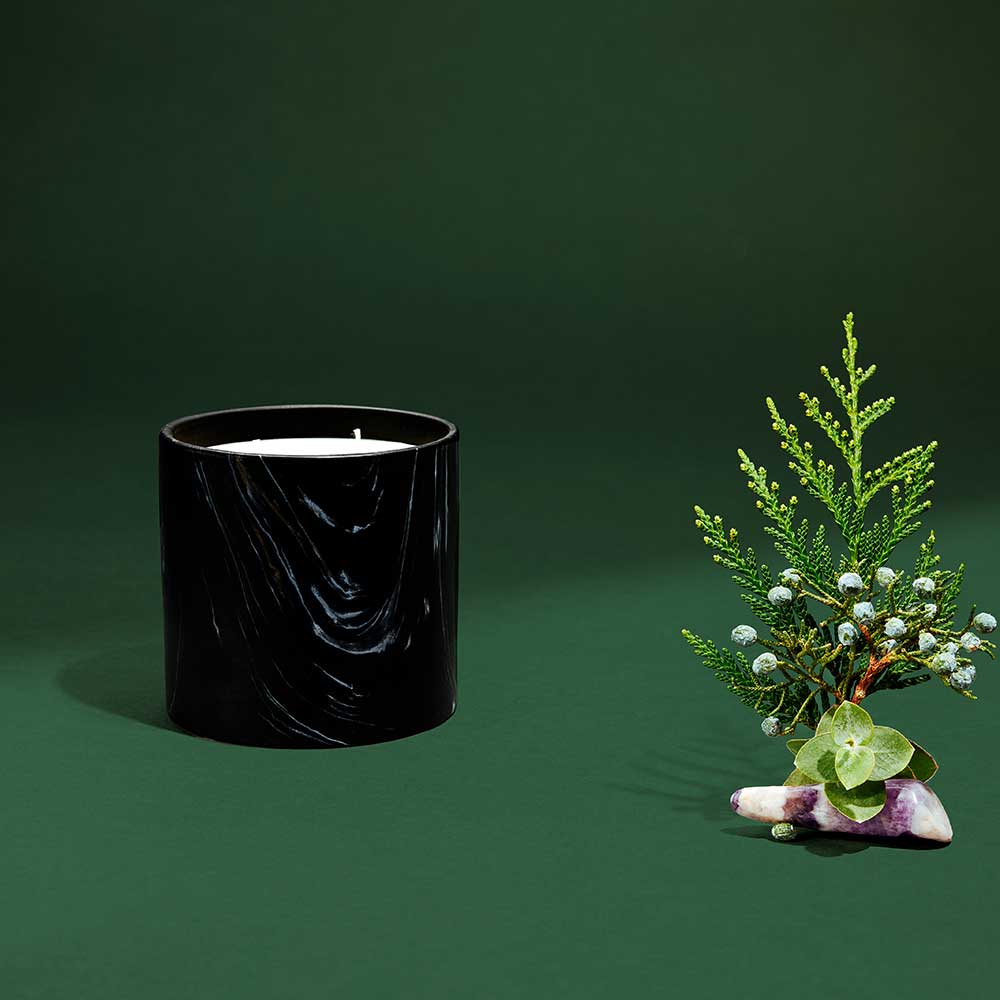Close-up of the marquina ceramic vessel showing intricate black, white, and gold swirls