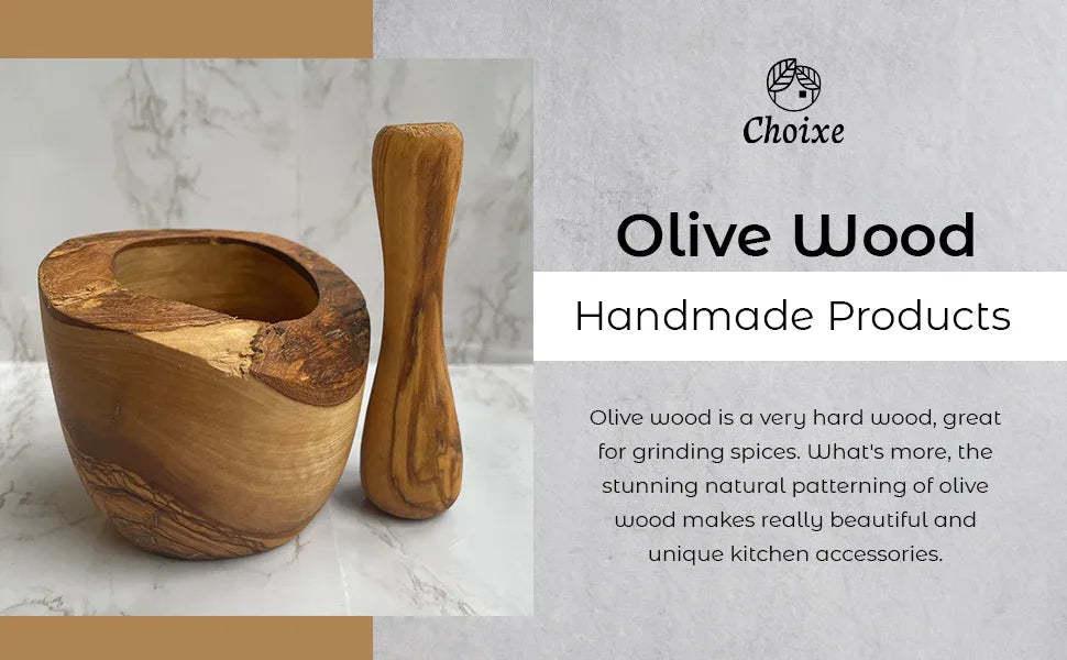 Top view of olive wood mortar and pestle on wooden countertop.