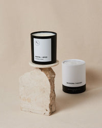 Close-up of the SANTAL + SPICE candle’s label highlighting its natural ingredients and clean design.
