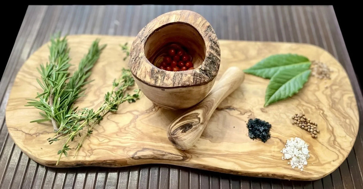 Pestle resting inside olive wood mortar showcasing smooth finish and durability.