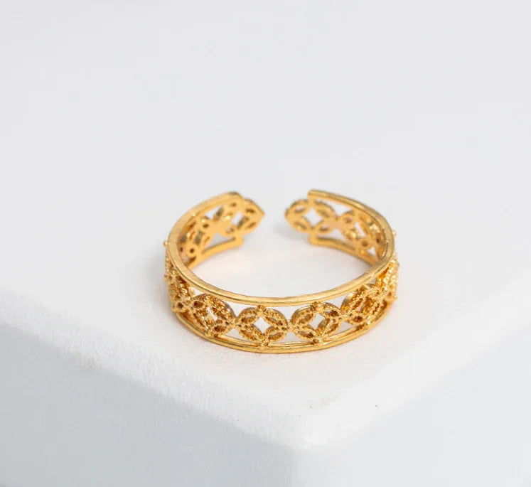 Hélodie Ring displayed on white background highlighting minimalist gold design and adjustable size