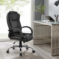 Assembled black PU leather office chair with ergonomic design on hardwood floor in office.
