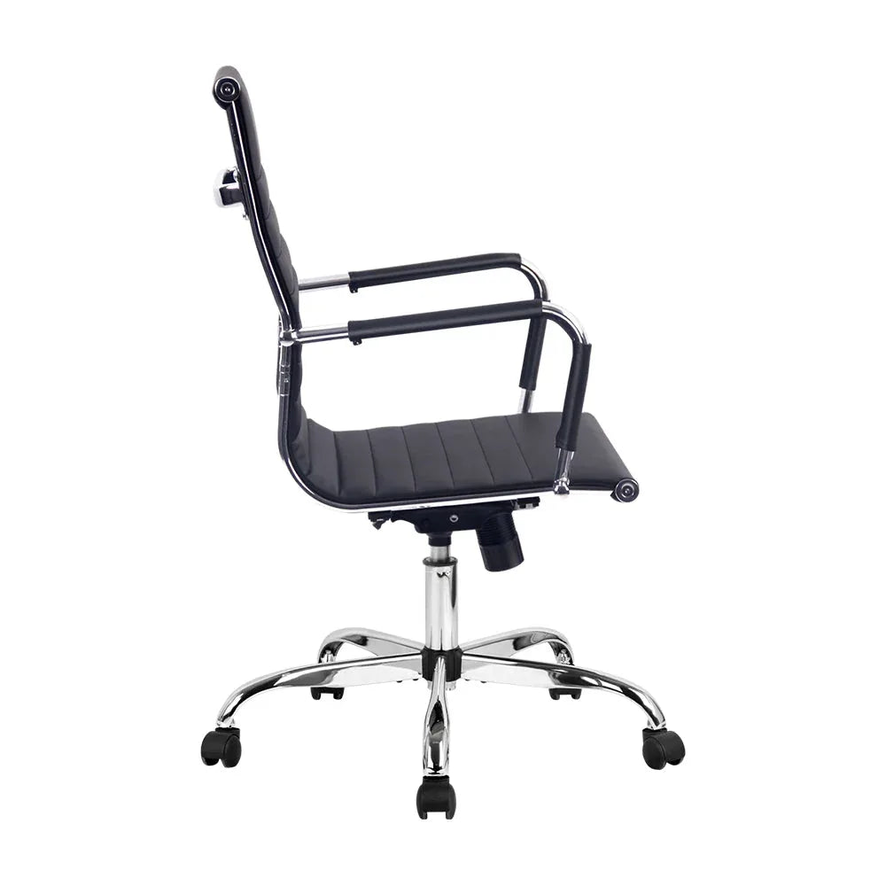 Close-up of black faux leather upholstery and padded armrest on the gaming office chair.