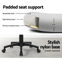 Office chair positioned at desk with ergonomic design and padded seat.