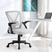 Close-up of mesh fabric on office chair’s backrest and cushioned seat.
