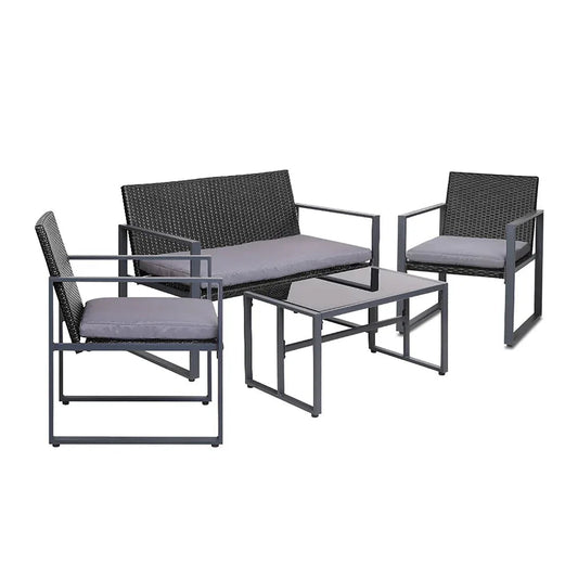 Black four-piece outdoor patio furniture set with table and cushioned chairs on patio.