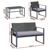 Close-up of black outdoor chair with thick cushion and woven PE wicker frame.