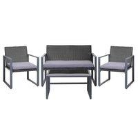 Black outdoor table with tempered glass top and modern square design in patio setting.