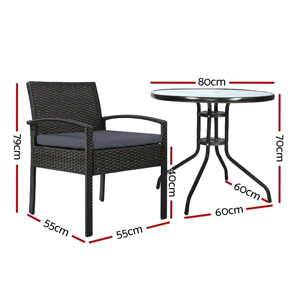 Outdoor wicker dining set showing one chair with beige cushion next to table with parasol hole.