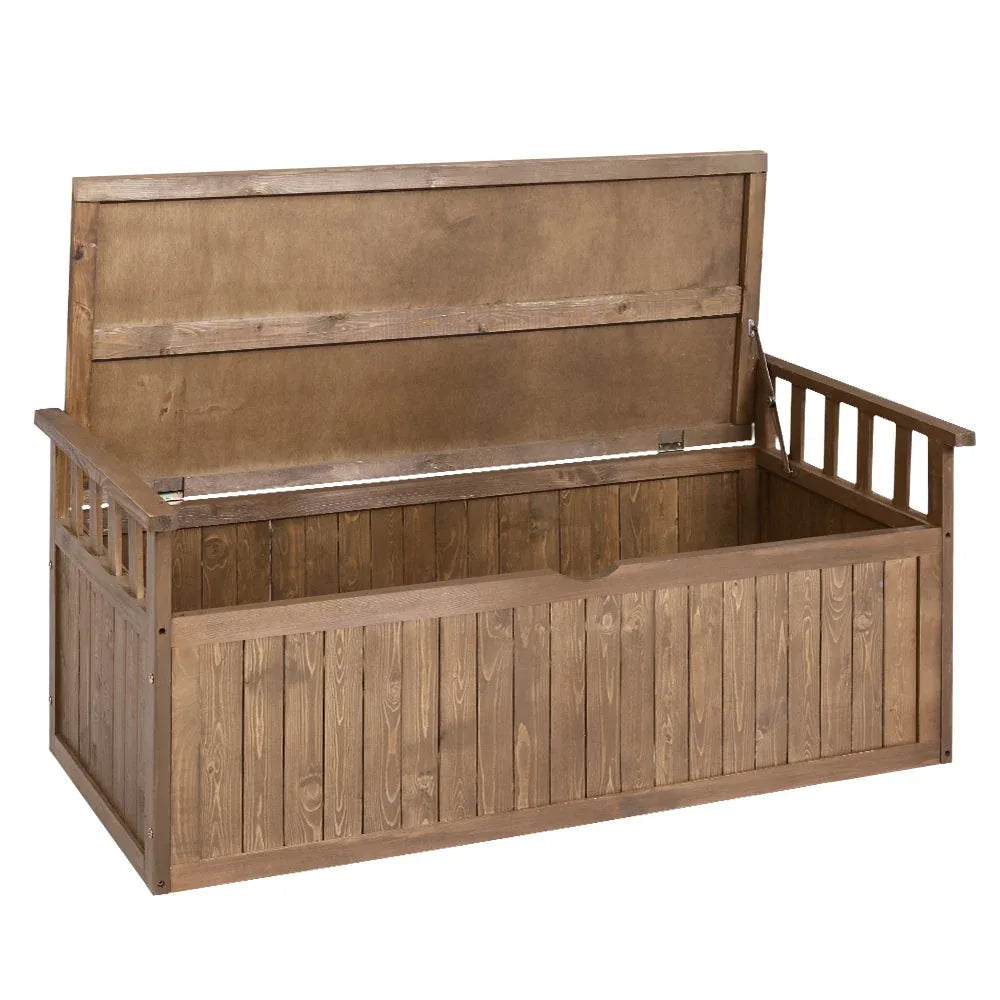 Outdoor wooden storage bench with hinged seat in natural fir wood on stone patio