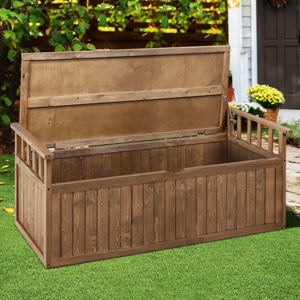 Wide angle shot of outdoor wooden storage bench beside plants on patio