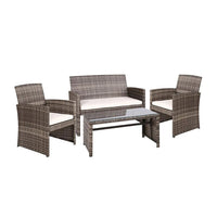 Gardeon 4-piece rattan outdoor lounge set with two armchairs, two-seater sofa, and glass-top table on patio.