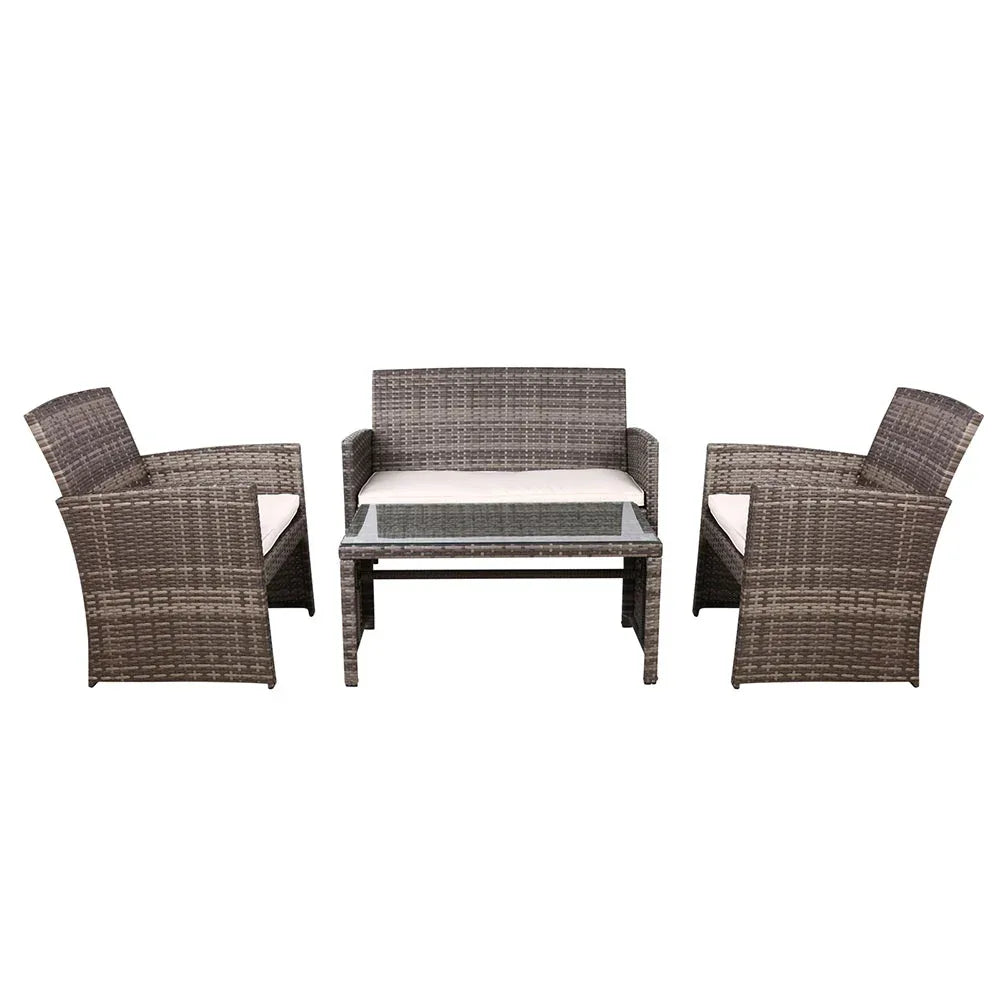 Two-seater rattan outdoor sofa with removable gray cushions placed beside matching armchair on wooden deck.