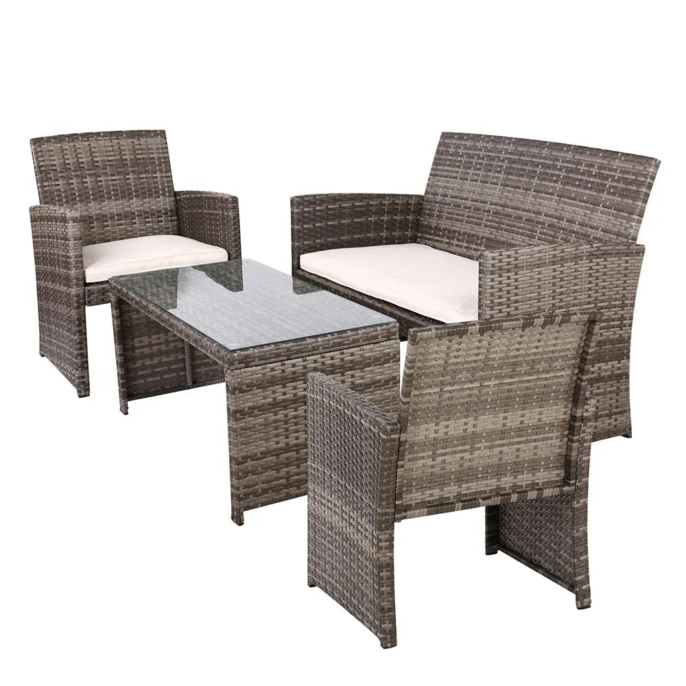 Glass-top coffee table with 5mm thick tempered glass and non-slip suction pads on rattan outdoor lounge set.