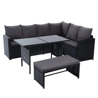 Black outdoor wicker bench seat of Gardeon dining sofa set on patio with cushions