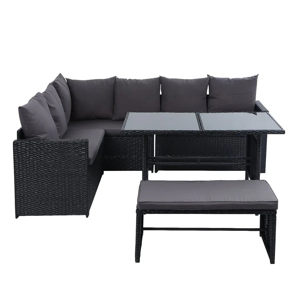 Side view of black wicker bench with plush cushions part of outdoor dining sofa set