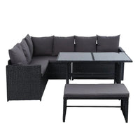 Side view of black wicker bench with plush cushions part of outdoor dining sofa set