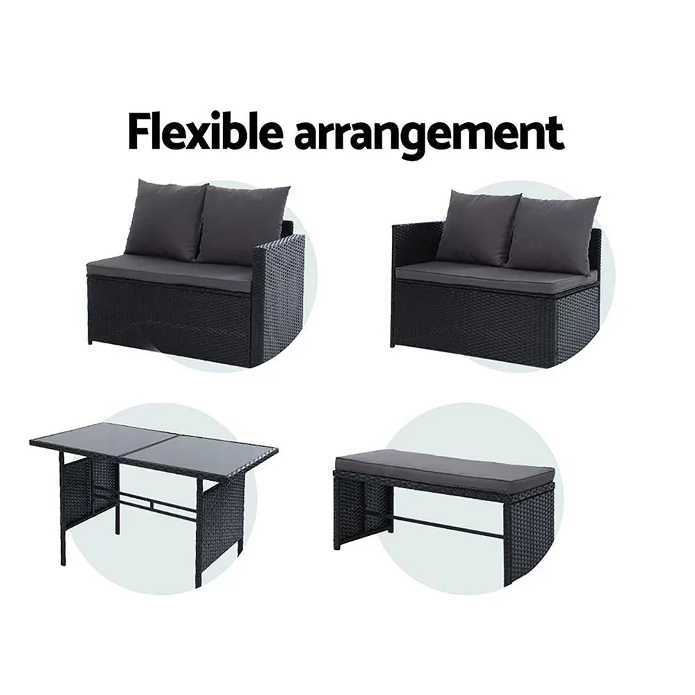 Detail of weather-resistant black wicker bench seat with comfy cushions in outdoor lounge