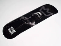 Side view of King Travis Skateboard showing colorful deck and black wheels.