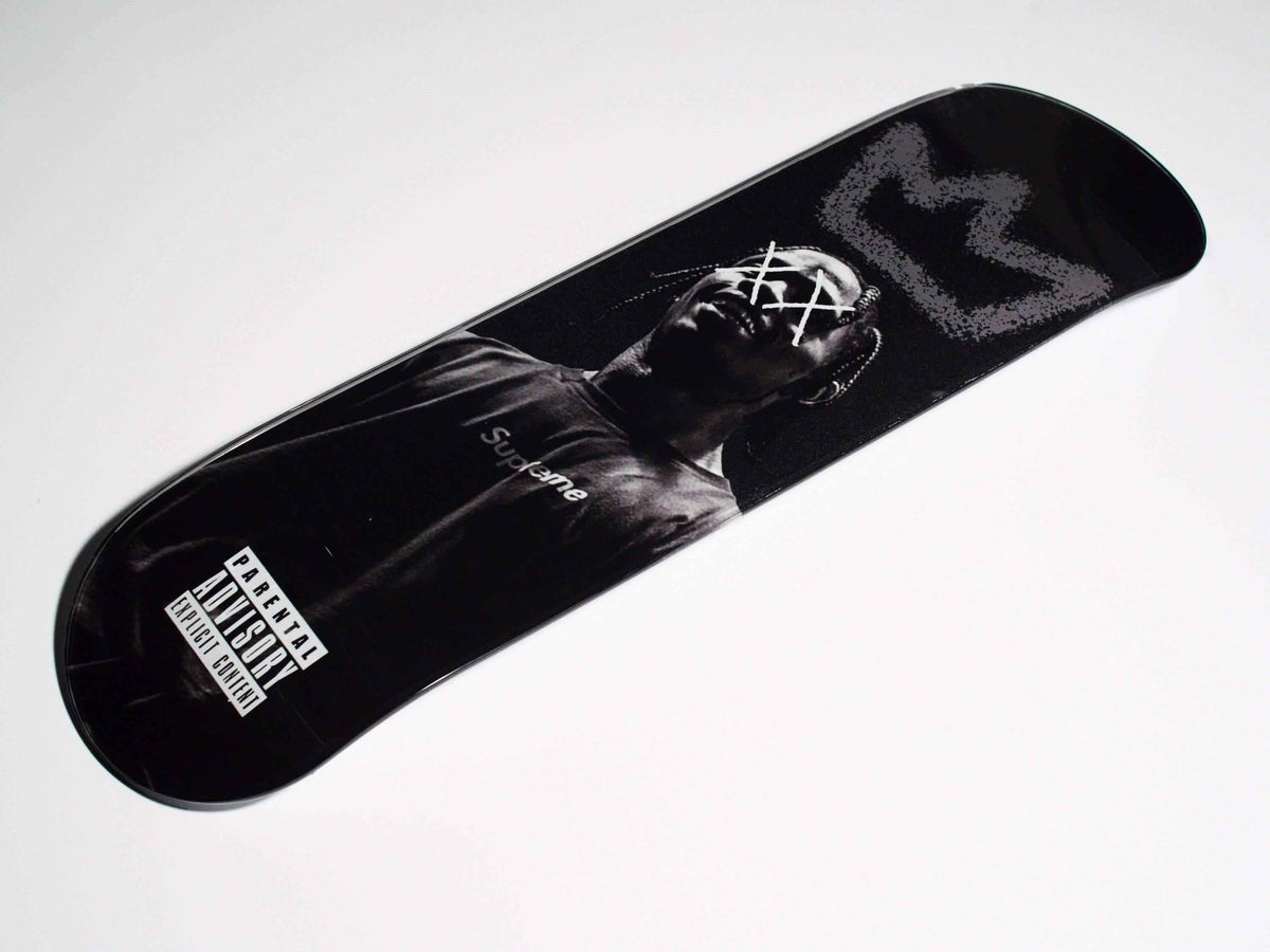 Side view of King Travis Skateboard showing colorful deck and black wheels.