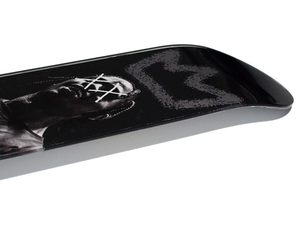 King Travis Skateboard displayed diagonally on white background.
