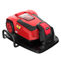 Side angle of the cordless robotic lawn mower navigating a lawn with boundary wire